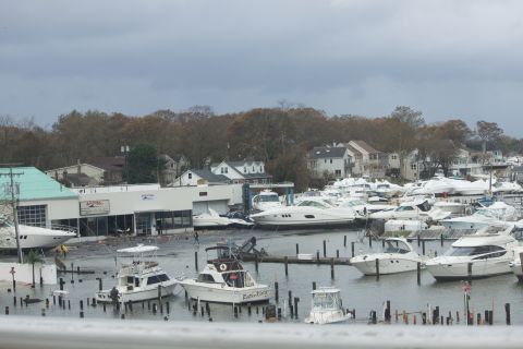 1990 Ford Bronco - A marina scene shows numerous boats, some partially submerged, in the aftermath of a storm.