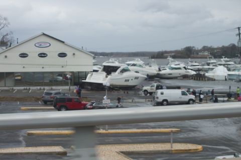 1990 Ford Bronco - Boats and vehicles are scattered around a marina, likely after severe weather.