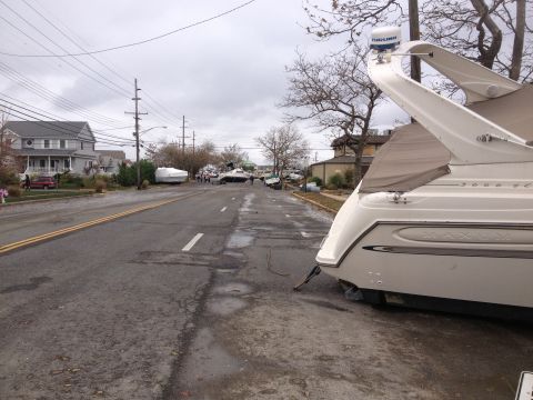 1990 Ford Bronco - Boats were displaced onto a street, likely due to the effects of Hurricane Sandy, disrupting the neighborhood.