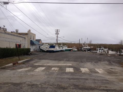 1990 Ford Bronco - Boats were displaced from the water and ended up on land, likely due to a storm.