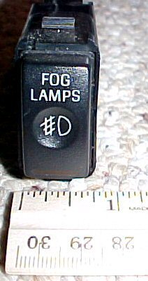2003 Ford Expedition - Close-up of a fog lamps switch with a ruler for scale.