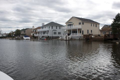 1990 Ford Bronco - A scene of waterfront houses and a boat, likely impacted by flooding.