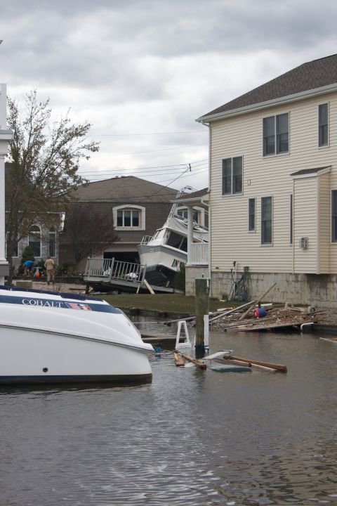 1990 Ford Bronco - Boats and debris litter the water and yards after a major storm caused flooding.
