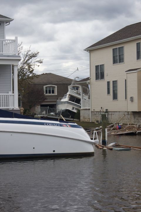 1990 Ford Bronco - Storm damage shows boats displaced and resting against residential structures.