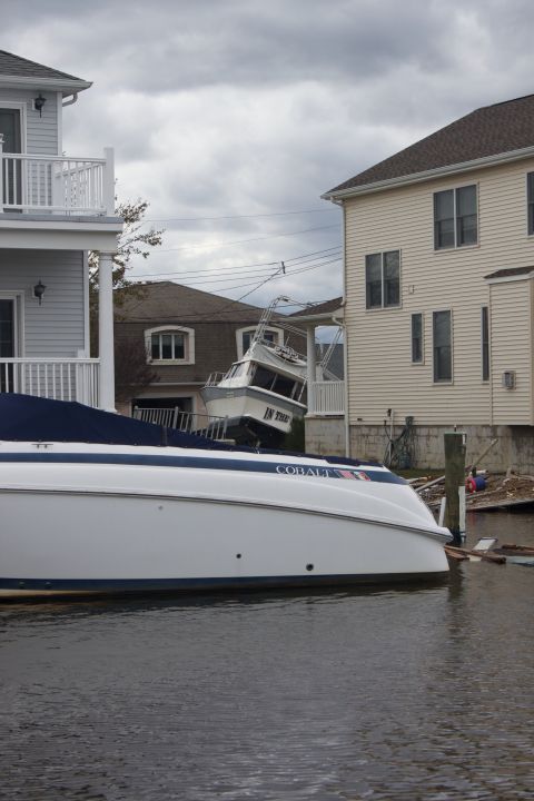 1990 Ford Bronco - Boats are seen stranded between houses after a storm.