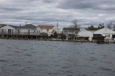 1990 Ford Bronco - Houses damaged by Hurricane Sandy stand on pilings near the water.