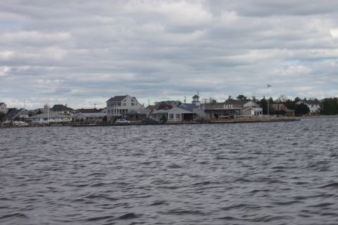 1990 Ford Bronco - A view of waterfront homes and a building with the label SATC on a cloudy day.