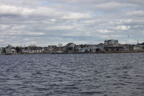 1990 Ford Bronco - A view of waterfront properties and a building labeled 'SAYC' across a body of water.