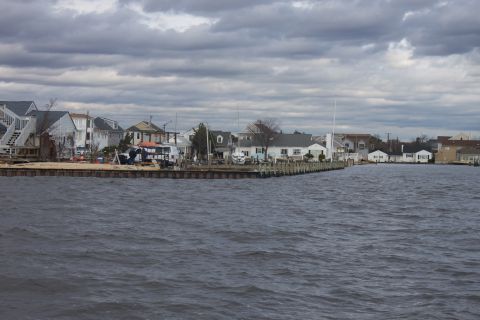 1990 Ford Bronco - A view of houses along a waterfront with a van visible on the dock.