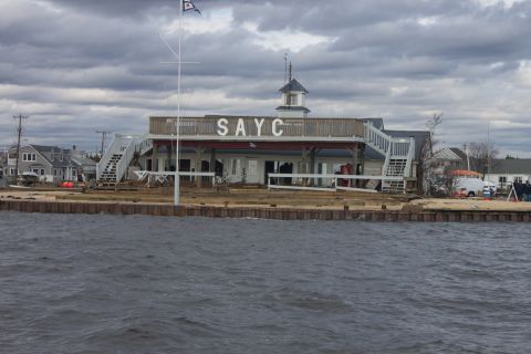 1990 Ford Bronco - A white van is visible near a building with "SAYC" signage, likely in the aftermath of Hurricane Sandy.