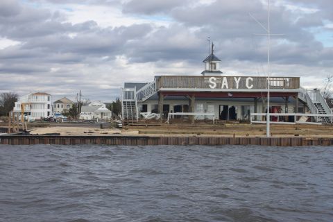 1990 Ford Bronco - Storm damage to a waterfront building and surrounding area.