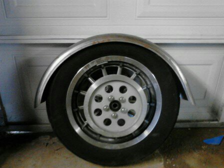 2003 Harley-Davidson Sportster - Motorcycle fender and wheel assembly shown against a garage door.