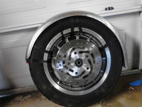 2003 Harley-Davidson Sportster - A close-up view of a motorcycle's rear wheel and fender assembly, with the brake rotor clearly visible.