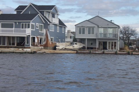 1990 Ford Bronco - Boat washed ashore near houses damaged by hurricane.