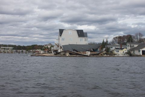 1990 Ford Bronco - Waterfront homes severely damaged by Hurricane Sandy, showing destruction and debris.