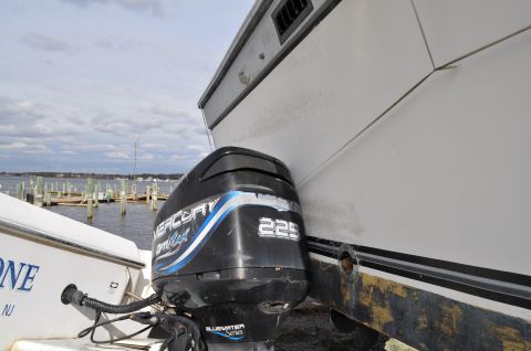 1990 Ford Bronco - A Mercury Optimax 225 outboard motor is shown attached to a boat, with another boat visible to the left.