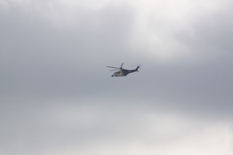 1990 Ford Bronco - Helicopter in flight against a backdrop of clouds.