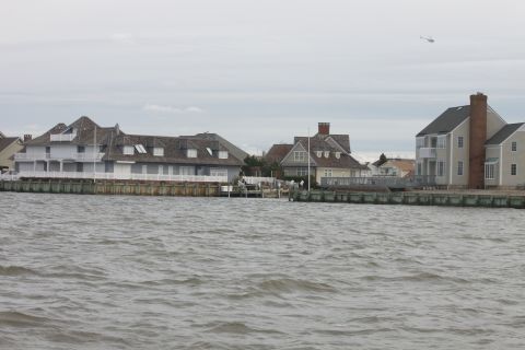 1990 Ford Bronco - A helicopter is visible in the sky above waterfront houses.