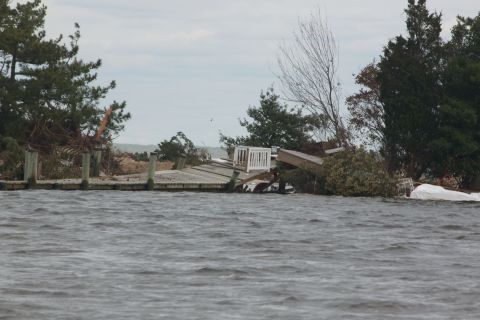 1990 Ford Bronco - A scene of destruction shows a damaged dock and scattered debris after a storm.