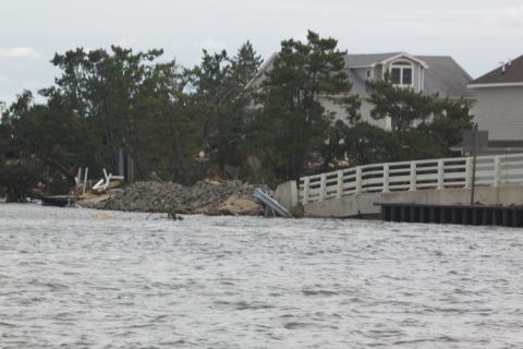 1990 Ford Bronco - A scene of destruction shows a damaged bridge and scattered debris after a storm.