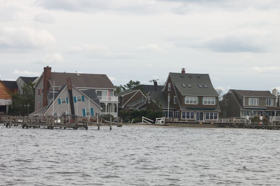 Waterfront houses with docks under cloudy sky