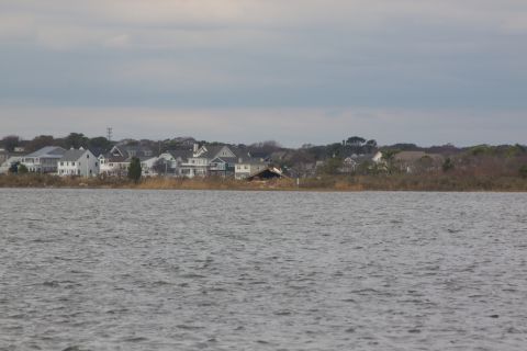 1990 Ford Bronco - A view of waterfront homes and a damaged building across the water.