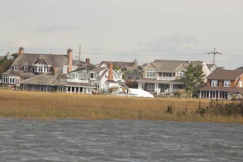 1990 Ford Bronco - A waterfront scene shows houses with visible storm damage, likely from Hurricane Sandy.