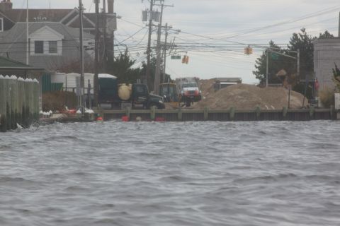 1990 Ford Bronco - Construction vehicles are visible on a pier during what appears to be a storm or flood event.
