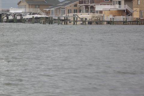 1990 Ford Bronco - Boats are seen docked near houses, likely damaged by flooding.