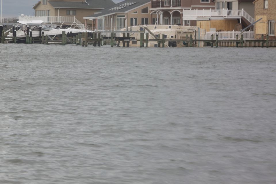 Boats on docks near houses with water damage