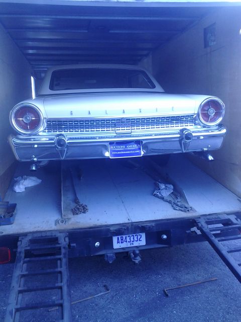1960 Ford Falcon - A 1960 Ford Galaxie is loaded onto a trailer, showing its distinctive rear end and grille.