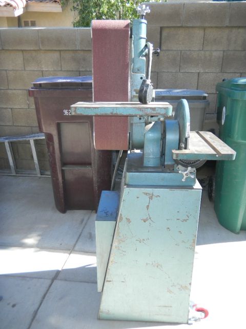 1997 Ford Ranger - A blue and green belt sander is shown outdoors next to two large trash bins.