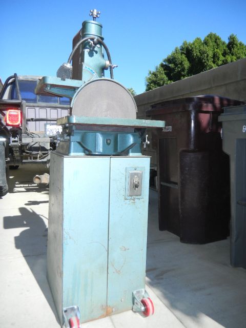 1997 Ford Ranger - A disc sander is parked next to a truck and trash bins under a clear blue sky.