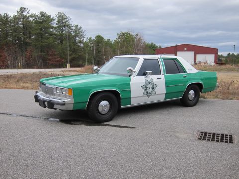 1991 Ford LTD Crown Victoria - This sheriff car has a star badge on the door with the word SHERIFF inside.