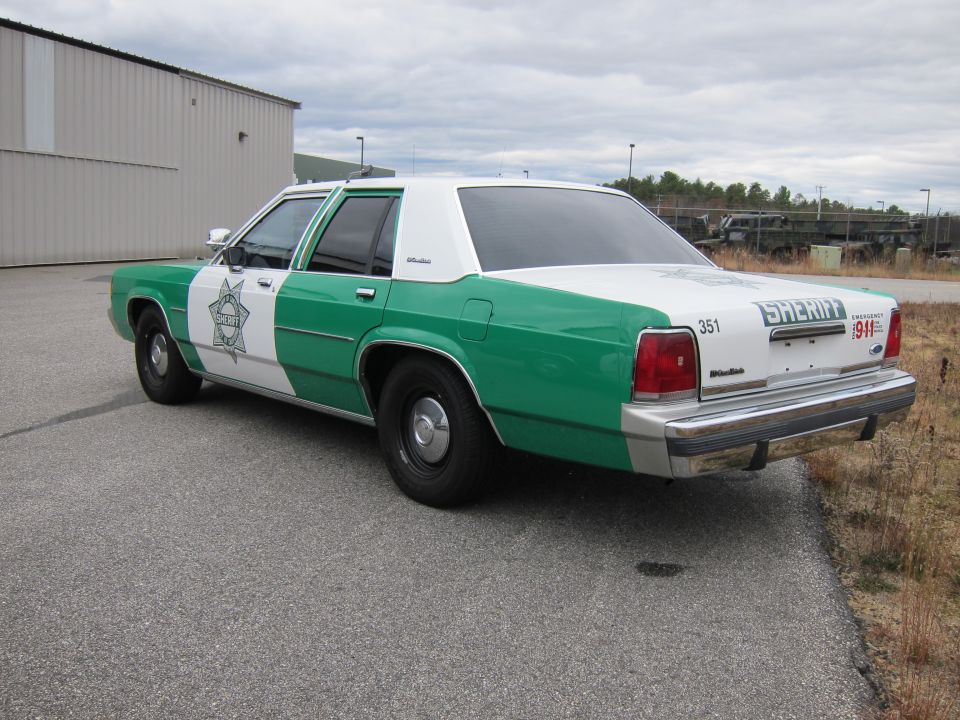 Rear view of a 1991 Ford Crown Victoria LTD sheriff's car, green and white
