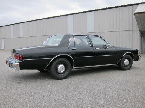 1991 Ford LTD Crown Victoria - This black sedan's body style suggests it is from the early 1980s, not a 1991 model.