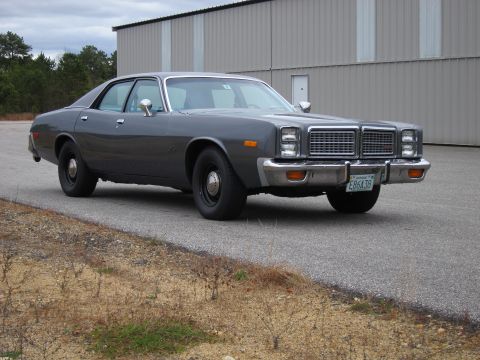 1991 Ford LTD Crown Victoria - Gray 1977 Plymouth Fury sedan with a chrome grille and bumper parked on asphalt.