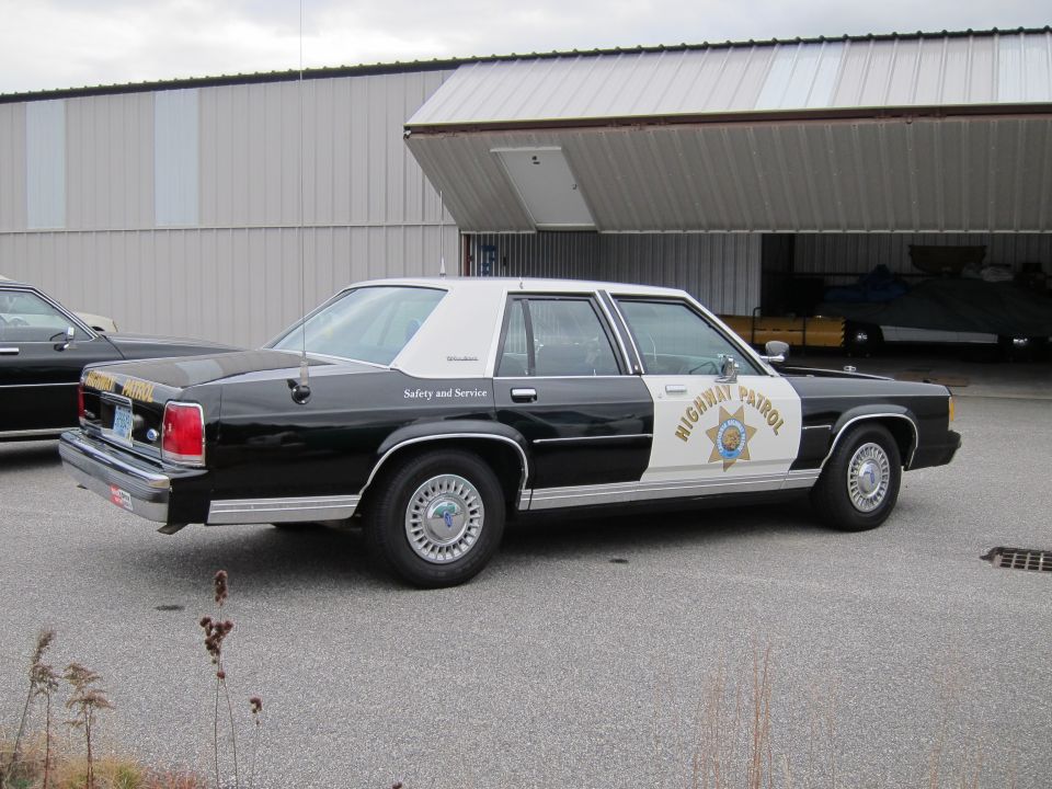 Black and white 1991 Ford Crown Victoria LTD highway patrol car, 3q front view