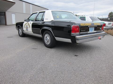 1991 Ford LTD Crown Victoria - This 1991 Ford Crown Victoria LTD, marked as a highway patrol vehicle, is seen from the rear with another patrol car visible behind it.