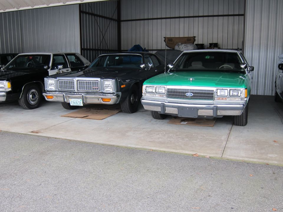 Green 1990 Ford Crown Victoria front view, parked in a garage
