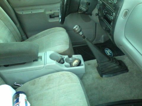 1993 Ford F-150 - Interior of a Ford truck with a manual transmission and center console visible.