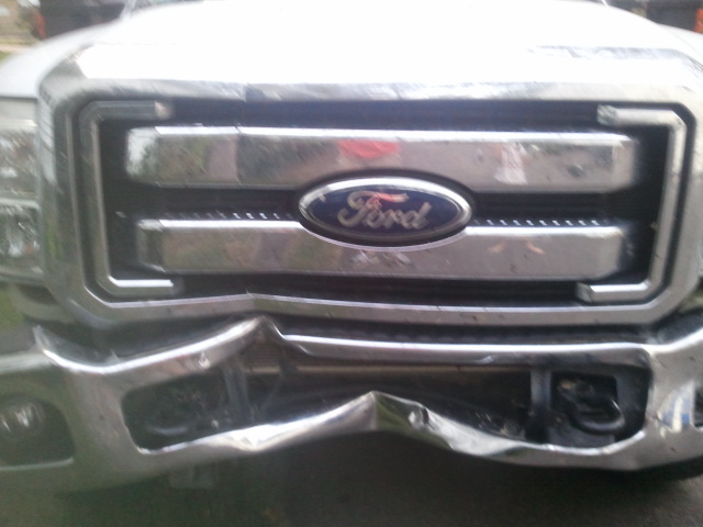 Front grille and bumper of a Ford truck with significant damage