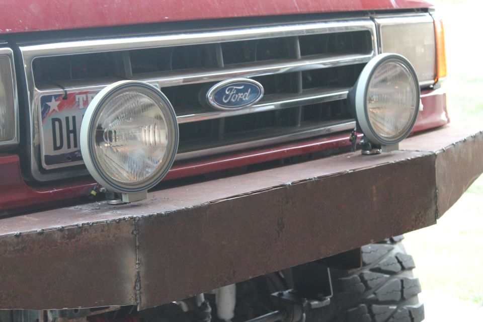 Red Ford Bronco front grille with aftermarket bumper and fog lights
