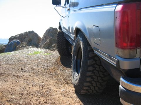 1989 Ford Bronco - This 1989 Ford Bronco is shown from the rear quarter angle, equipped with large tires for off-road terrain.