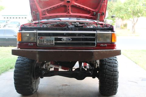 1990 Ford Bronco - This 1990 Ford Bronco features a custom front bumper and its hood is open, revealing the engine bay.