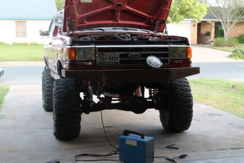 1990 Ford Bronco - This 1990 Ford Bronco features a custom front bumper and its hood is open, revealing the engine bay.