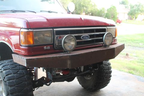 1990 Ford Bronco - Front view of a 1990 Ford Bronco with a custom bumper and off-road tires.