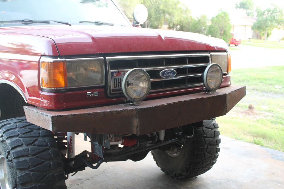1990 Ford Bronco front end with custom steel bumper and auxiliary lights. "5.8" badge visible