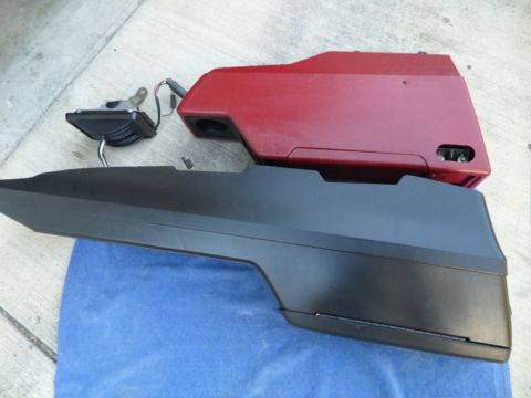 1994 Jeep Cherokee - Two automotive interior trim pieces are laid out on a blue cloth and concrete surface.