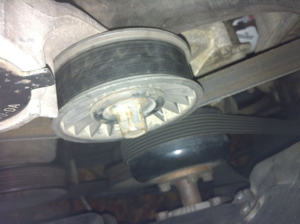 Old, noise and loose tensioner pulley.